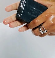 Carbontheory Activated Charcoal Soap Bar held in hand for deep cleansing skin care